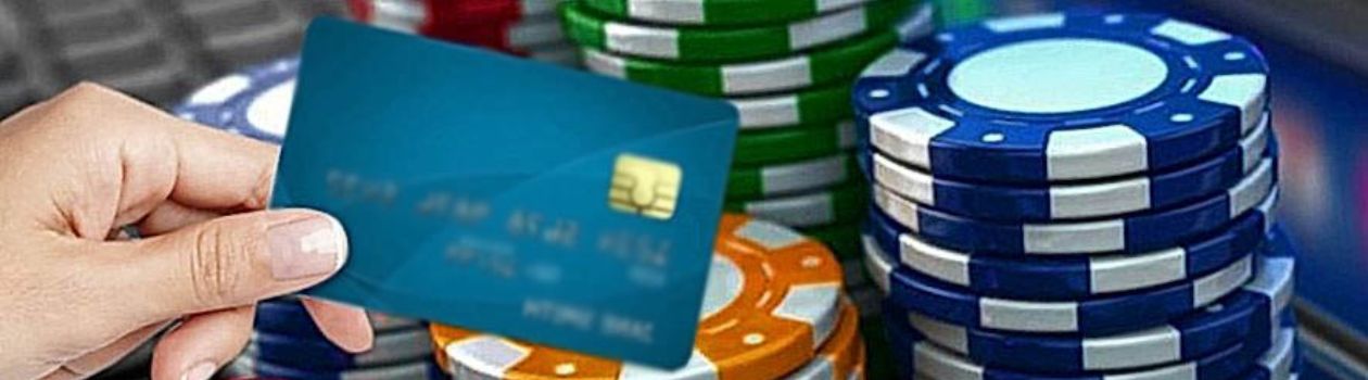 credit card in hand against the background of casino chips